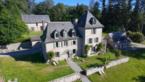 an aerial view of a large stone house at Le Château de Saint-Angel, Le Manoir du Rigouneix, 5 minutes A89, nature, calme, sauna, CLIMATISATION in Saint-Angel