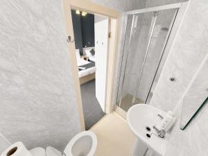 a bathroom with a sink and a toilet and a shower at Highfield Hotel Blackpool in Blackpool +42 photos