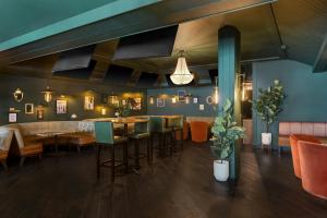 a restaurant with a bar with tables and chairs at FOUND Hotels, Chicago, Series by Marriott in Chicago
