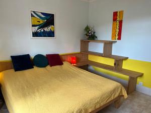 a bedroom with a bed and a shelf on the wall at Appartement Ingwer, Floramar in Candelária +23 photos