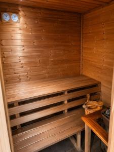 a wooden sauna with a bench in a room at Villa Retró Harmónia in Visegrád