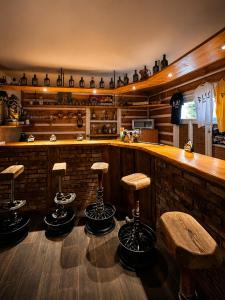 a bar with stools in a room with a counter at Basecamproll in Pec pod Snezkou +4 photos