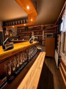 a bar with wine glasses on a wooden counter at Basecamproll in Pec pod Snezkou