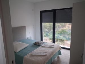 a bedroom with a bed and a large window at Quinta das Reveladas in Marvão +64 photos