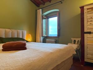 a bedroom with a large bed with a window at Villa Fioriamo in Greve in Chianti +248 photos