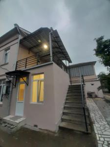 a house with a staircase leading up to it at Iren Apartment in Batumi