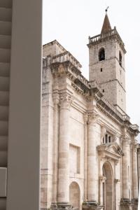 a black and white photo of a church with a tower at PALAZZO CIOTTI in Ascoli Piceno