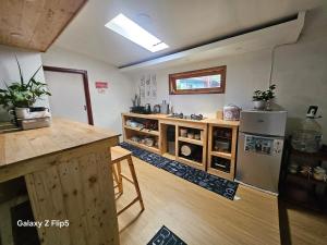 a kitchen with a counter and a refrigerator in it at Erigeron homestay dieng in Banjarnegara
