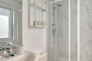 a white bathroom with a shower and a sink at Rotkäppchen in Dörverden +22 photos
