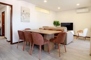 a dining room with a table and chairs at Bright & Spacious Flat with Balcony by HostWise in São Mamede de Infesta