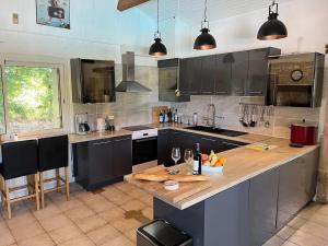 a large kitchen with a large island in a kitchen at Sleeps10-PrivatePool-GamesRoom-GatedGardens in Paizay-le-Chapt