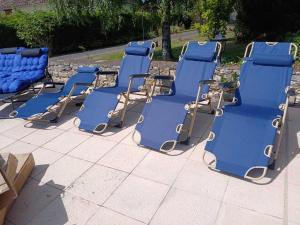 a group of blue chairs sitting on a patio at Sleeps10-PrivatePool-GamesRoom-GatedGardens in Paizay-le-Chapt