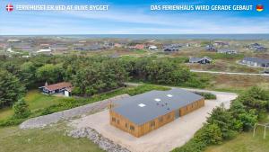 an overhead view of a large building in a suburb at Eksklusivt Luksusferiehus Med Pool Sj455 in Harboør