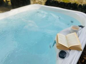 a book and a cup of coffee in a bath tub at Hollow Brook grown ups escape peace and quiet in Eyam