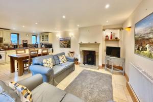 a living room with a couch and a fireplace at Hollow Brook grown ups escape peace and quiet in Eyam