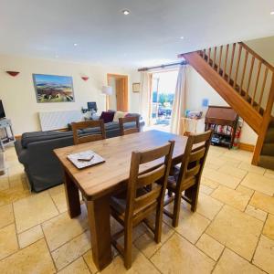 a living room with a wooden table and chairs at Hollow Brook grown ups escape peace and quiet in Eyam