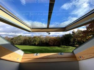 a large window in a room with a view at Pretty Wood Cottage Quiet Cottage in Private Meadow in Eyam