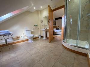 a bathroom with a shower and a toilet and a sink at Riley Wood Cottage Peaceful Cottage, Views & Walks in Eyam +83 photos