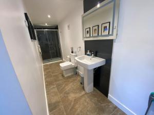 a bathroom with a sink and a toilet at Barn Peaceful Stay with Far-Reaching Views in Eyam