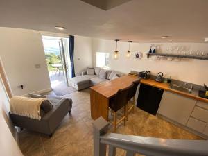 a kitchen and living room with a couch and a table at Barn Peaceful Stay with Far-Reaching Views in Eyam