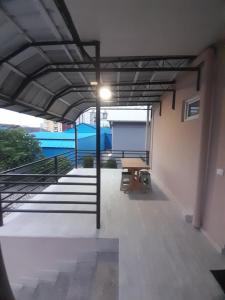 an empty room with a table and stairs in a building at Iren Apartment in Batumi