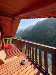 a balcony of a cabin with a view of a river at HiraBungalov in Çamlıhemşin