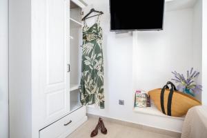 a living room with a tv and a door at Hvar Villa Maris in Hvar