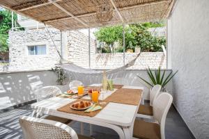 a white table and chairs on a patio at Hvar Villa Maris in Hvar