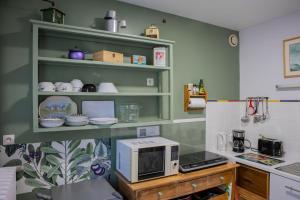 a kitchen with a microwave sitting on a counter at Clos Sainte Anne avec piscine in Cour-Cheverny
