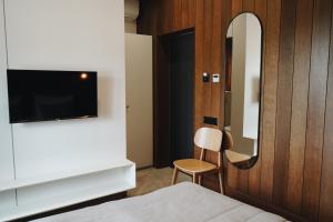 a bedroom with a bed and a mirror and a chair at Камінь in Ostrovets