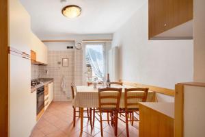a kitchen and dining room with a table and chairs at Casa Heidi in Castello Tesino