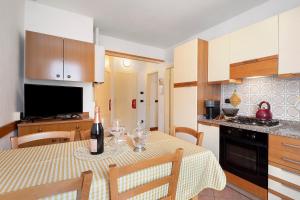 a kitchen with a table with a bottle of wine on it at Casa Heidi in Castello Tesino +23 photos