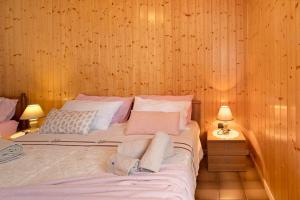 a bedroom with a bed with two pillows on it at Casa Heidi in Castello Tesino