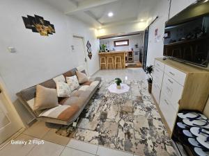a living room with a couch and a table at Erigeron homestay dieng in Banjarnegara