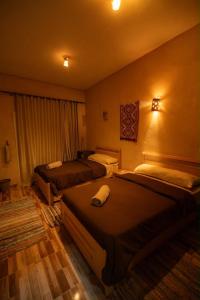 a hotel room with two beds in a room at Ayur Lodge Siwa Oasis in Siwa +78 photos