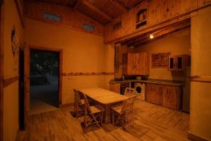 a kitchen with a table and chairs in a room at Ayur Lodge Siwa Oasis in Siwa