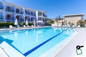 a large swimming pool in front of a building at Hotiday Zakynthos Argassi in Zakynthos