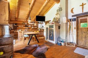 a living room with a table and a fireplace at Chalet 4 in Sankt Englmar +13 photos
