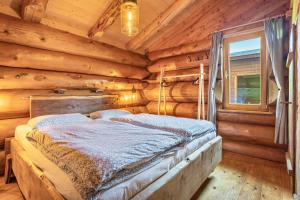a bedroom with a bed in a log cabin at Chalet 4 in Sankt Englmar