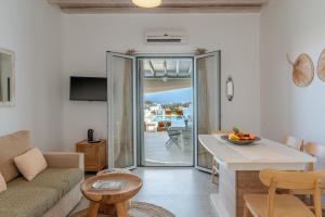 a living room with a couch and a table at Villa blaue Welle in Kalo Livadi