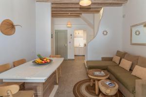 a living room with a couch and a table at Villa blaue Welle in Kalo Livadi