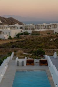 a swimming pool in front of some white buildings at Villa blaue Welle in Kalo Livadi