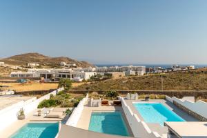 a view of a resort with two swimming pools at Villa blaue Welle in Kalo Livadi