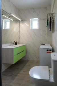 a bathroom with a sink and a toilet at Amfithea Guest House in Amfithea +69 photos
