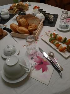 a table with a table cloth with bread and plates at La Parenthese in Folles