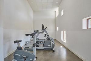 a gym with two exercise bikes in a room at Résidence Odalys Terra Gaia in Sète