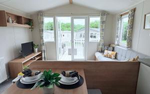 a living room with a couch and a table at Coastal Escape in Heysham