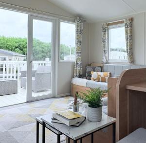 a living room with a bed and a table at Coastal Escape in Heysham