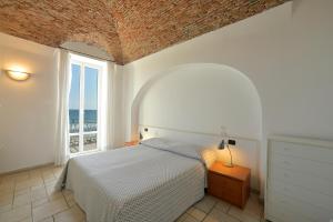 a bedroom with a bed and a large window at Hotel La Balnearia in Alassio