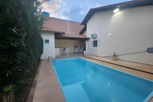 a swimming pool in the backyard of a house at Campo Grande Guest Flat in Campo Grande